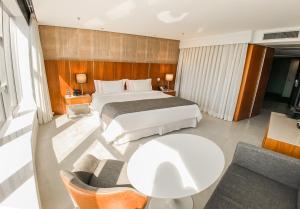 a hotel room with a bed and a table at Hotel Nacional Rio de Janeiro - OFICIAL in Rio de Janeiro