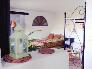 a bedroom with a bed and a table with a lantern at Casa Mariposa in Casares