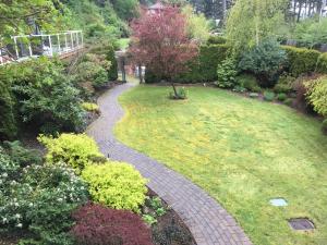 a brick walkway in a garden with a lawn at Kye Bay BnB - A Place to Breathe in Comox
