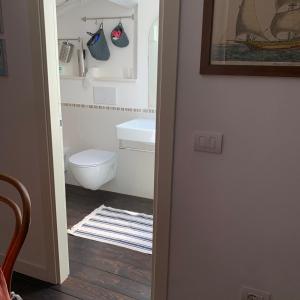 a bathroom with a toilet and a sink at La Trabacca, attico nel pieno centro di Levanto in Levanto +39 photos