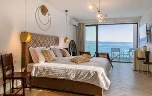 a bedroom with a bed with a view of the ocean at Gallery Luxury Suites & Rooms-Only Adults in Split