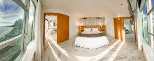 a bedroom with a bed and a view of the ocean at Hotel Nacional Rio de Janeiro in Rio de Janeiro