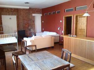 a living room with a table and a couch at Wohnung Nikolaiblick in Wismar