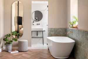 a bathroom with a white tub and a sink at Hotel Noel - A Boutique Experience by Albi Collection in Jerusalem