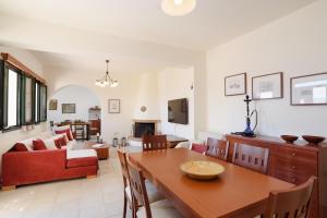 salon ze stołem i czerwoną kanapą w obiekcie Villa Meitani w mieście Kattavía