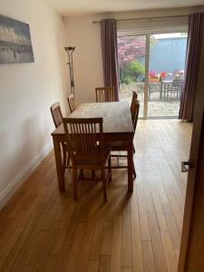 comedor con mesa, sillas y ventana en Feather bed 3 bedroom house en Kinsale