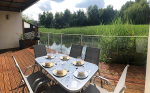 a table with plates of food on a deck at Harrier Lodge in Cirencester +25 photos