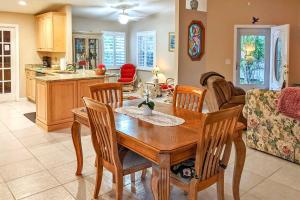 a kitchen and living room with a wooden table and chairs at Pet-Friendly Home with Yard - 2 Blocks to Beach in Flagler Beach