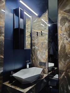 a bathroom with a sink and a mirror at Pasta Amber Lux in Liepāja