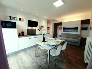 a kitchen and living room with a table and chairs at Ca' del Barba in Domaso