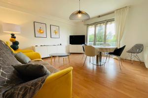 uma sala de estar com um sofá e uma mesa em La Belle Ferronnière appartement avec environnement paisible em Amboise