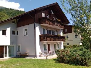 a large white building with a balcony at Haus Edelweiss Mölltal in Flattach