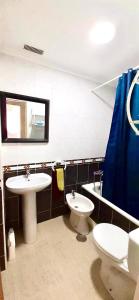 a bathroom with a sink and a toilet and a mirror at 2 línea Cala del Palangre in Torrevieja