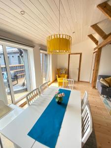 a dining room with a white table and chairs at Eva in Liepāja