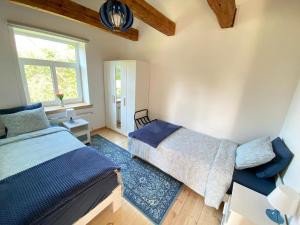a bedroom with two beds and a window at Eva in Liepāja