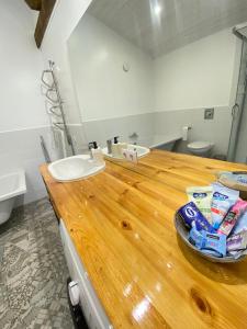 a bathroom with a wooden counter with a sink at Eva in Liepāja +20 photos