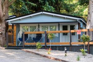 a small house with two blue chairs in it at Kintala Resort & Spa in Dungiven