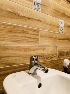a bathroom sink with a faucet on top of it at Appartamento Cuore in Montemerano