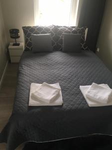 duże łóżko z dwoma białymi ręcznikami w obiekcie Apartament Słoneczny Taras w Kołobrzegu