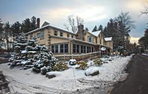 a house with snow covered trees in front of it at Woodfield Manor - A Sundance Vacations Property in Cresco
