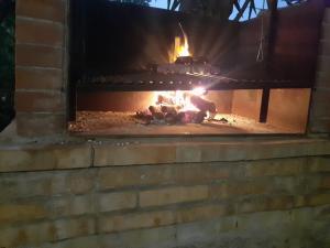 a brick oven with a fire in it at Litto Appartamenti in Tropea
