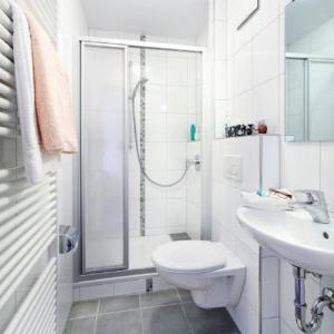 a bathroom with a shower and a toilet and a sink at Landgasthof Löwen in Oberopfingen