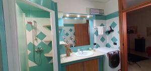 a bathroom with a sink and a shower at Casa Tizy in Botrugno +23 photos
