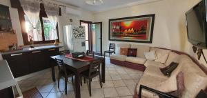 a living room with a couch and a table at Casa Tizy in Botrugno