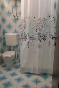 a bathroom with a toilet and a shower curtain at Agava Apartments Begic in Makarska +32 photos