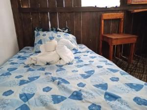 a bed with a stuffed animal laying on it at Sustainable Cabain in Cozumel +11 photos