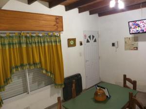 Una sala de estar con una mesa y una ventana. en Apartamento El Calvario 3, en Tandil
