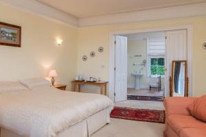 a bedroom with a bed and a bathroom at Lammas Park House in Dawlish