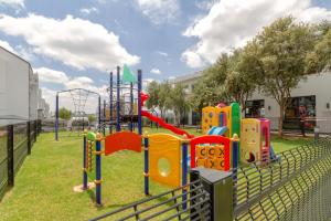 a park with a playground with a slide at Villa Valentino Greenstone Ridge WiFiNetflix in Edendale