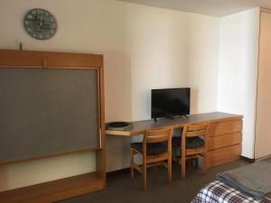 a classroom with a desk with a computer and a chalkboard at Brides-les-Bains family ski and spa appartment in Brides-les-Bains