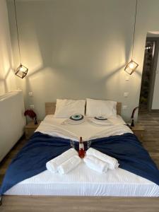 a bedroom with a bed with two towels on it at Overwave Apartment in Kavála