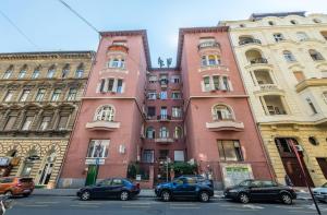 two tall buildings with cars parked in front of them at Central Studio Budapest in Budapest