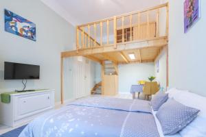 a small bedroom with a bed and a loft at Central Studio Budapest in Budapest +20 photos