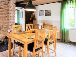 a dining room with a wooden table and chairs at Holiday home SÖLVESBORG XI in Sölvesborg