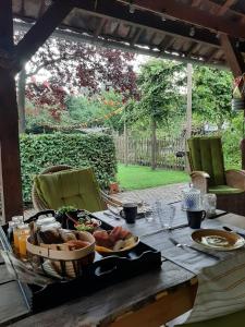 a table with plates of food on top of it at Thuis bij Elles in Zuilichem