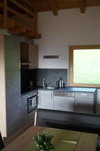 a kitchen with stainless steel appliances and a window at Apartment Auszeit in Ellbögen