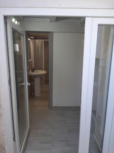 eine offene Tür zu einem Bad mit einem Waschbecken in der Unterkunft Casa di Carmine 2 in Galatina