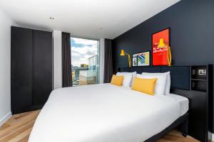 a bedroom with a bed and a painting on the wall at Staycity Aparthotels Manchester Northern Quarter in Manchester