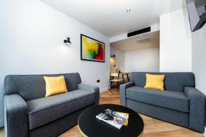 ein Wohnzimmer mit 2 Sofas und einem Tisch in der Unterkunft Staycity Aparthotels Manchester Northern Quarter in Manchester