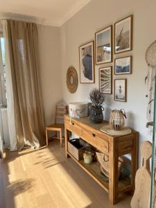 a living room with a table and pictures on the wall at Apartament Joanna in Rabka-Zdrój