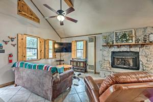 a living room with a couch and a fireplace at Ruidoso Cabin with Deck and Grill - Walk to Town! in Ruidoso