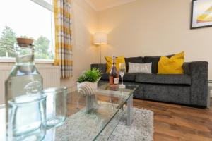 a living room with a couch and a glass table at TAYLOR HOUSE contractors welcome OFF STREET parking for vans in Durham
