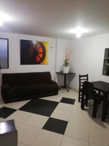 a living room with a couch and a table at HOTEL LA RUEDA SR in Barbosa