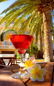 a drink sitting on a table with flowers on it at Kissamos Hotel in Kissamos