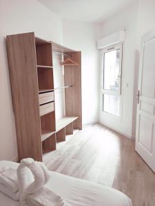 a white room with a bed and a closet at Aéroport Roissy CDG - Parc Astérix - Parc des expositions in Louvres +9 photos