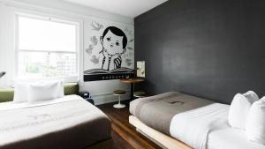 a room with two beds and a painting on the wall at Ace Hotel Portland in Portland
